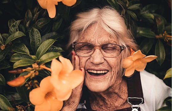 Senior practices mindful aging in flower garden